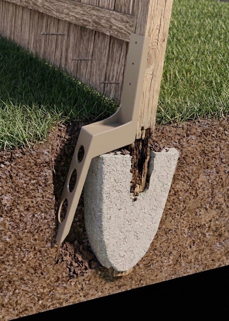 Tan patented Lean On Me steel fixture fitted around a 4x4 wooden fence post beside the original concrete footing